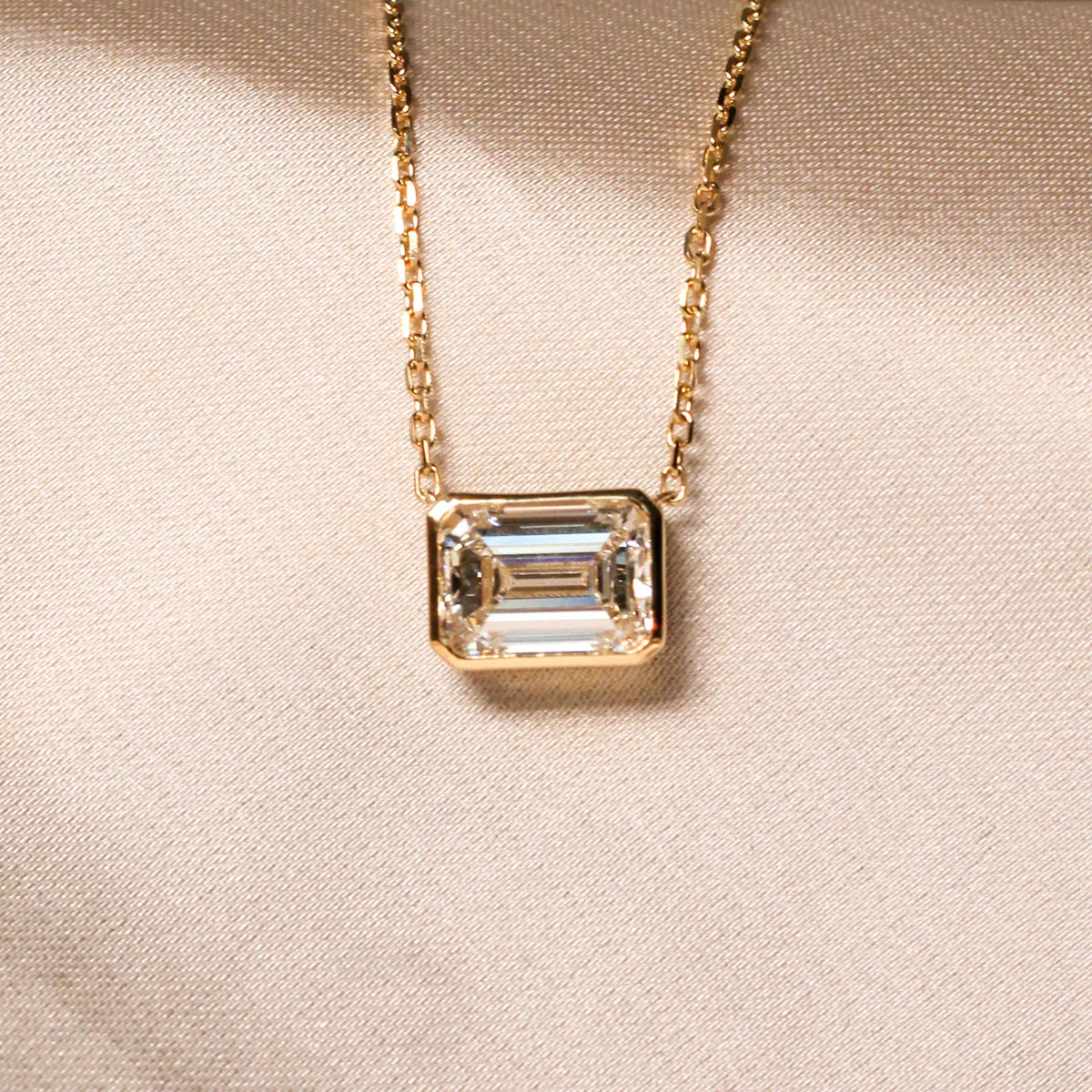 Emerald-Cut Diamond East-West Full-Bezel Solitaire View 4